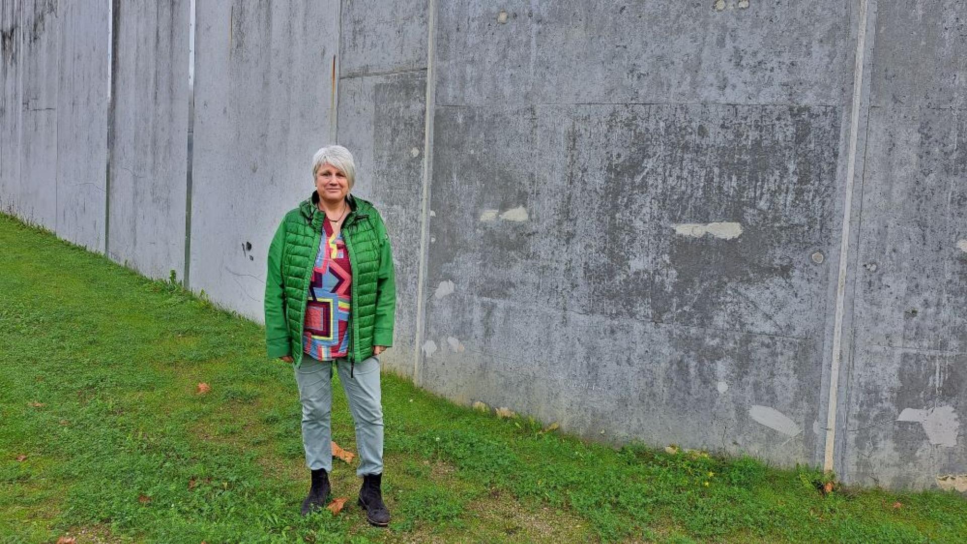 Seelsorgerin Evi Lotz-Thielen vor der Mauer der Haftanstalt