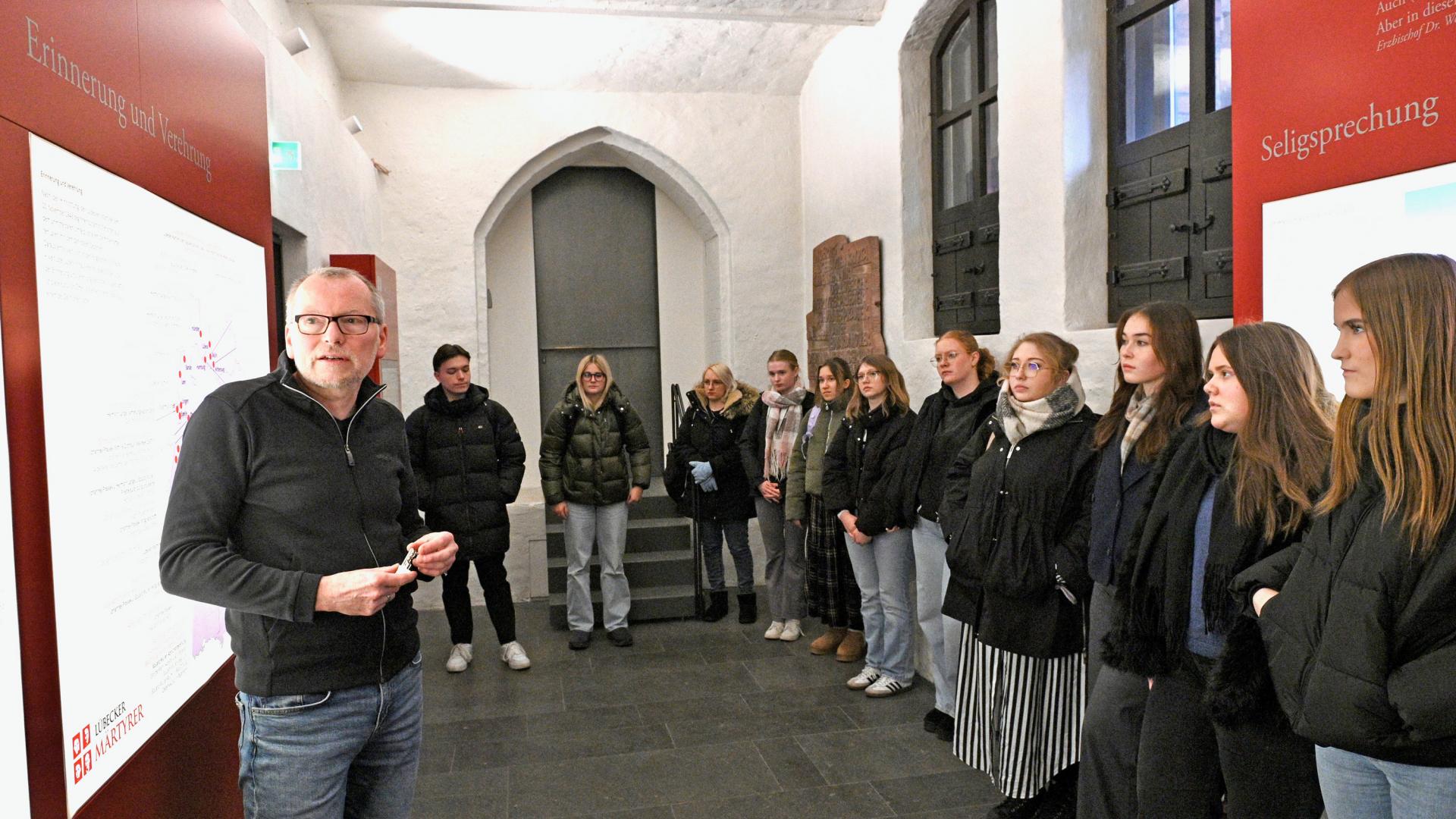 Junge Menschen betrachten eine Ausstellung.