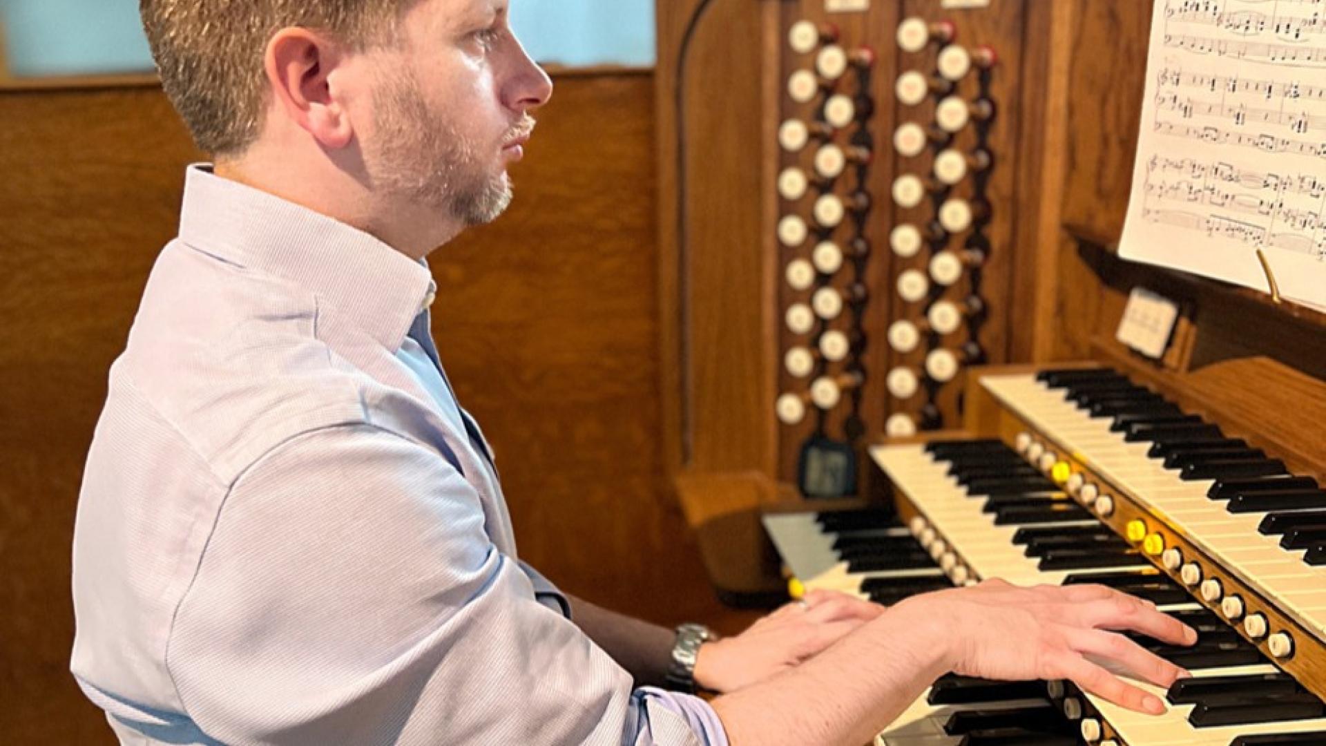 Ein Mann spielt an einer Orgel